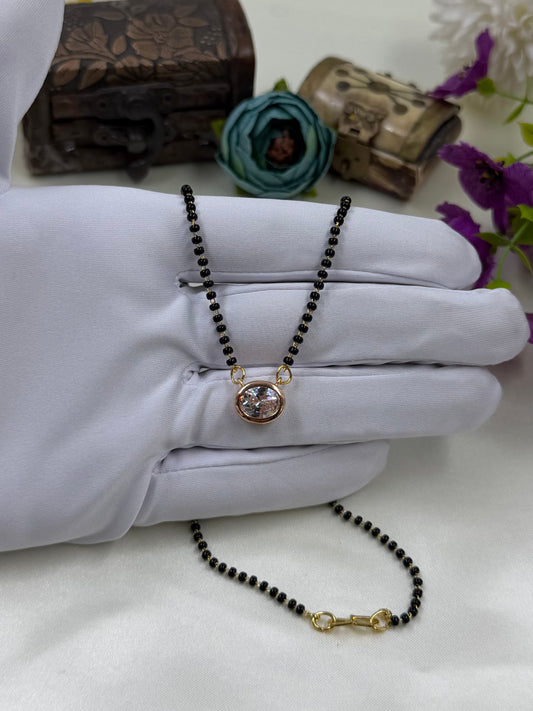 White Mangalsutra detail shot showing intricate work