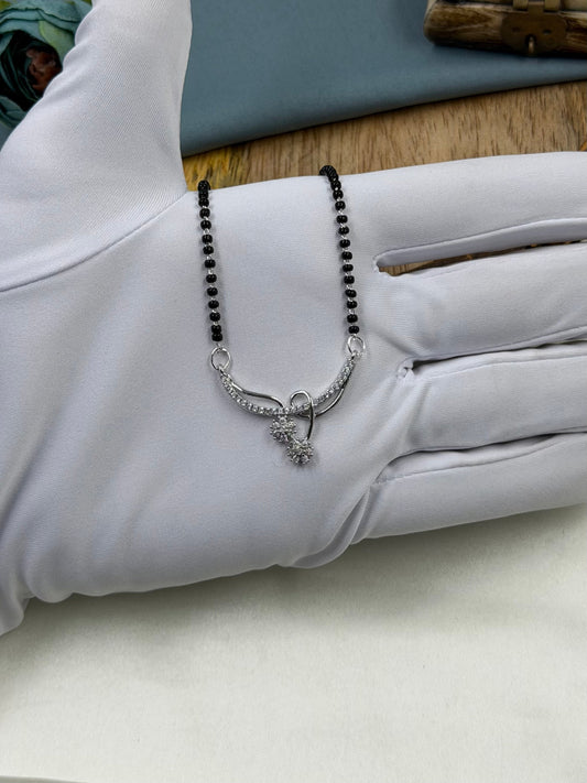 White Mangalsutra detail shot showing intricate work