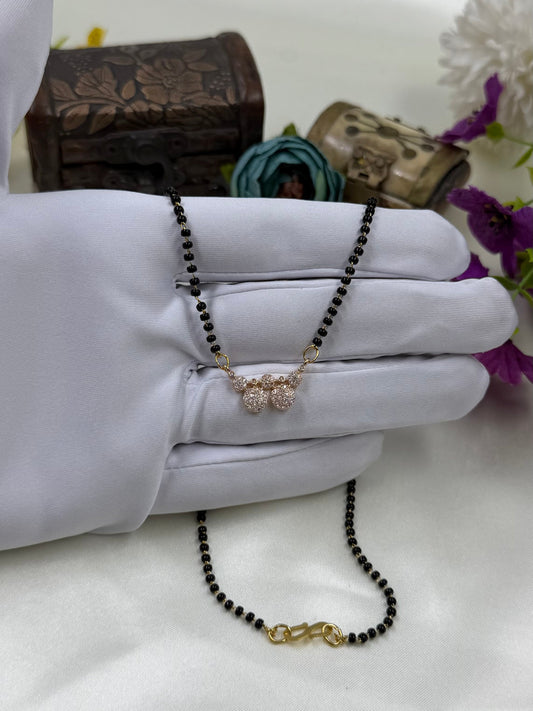White Mangalsutra detail shot showing intricate work