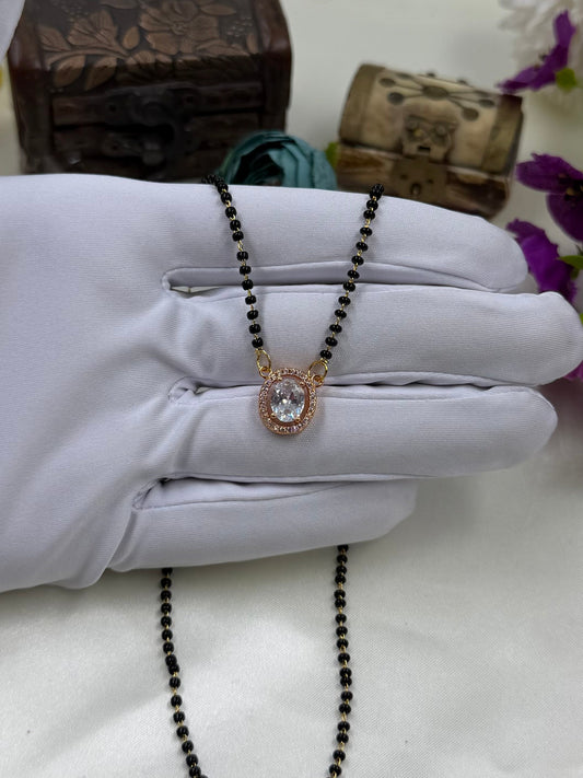 White Mangalsutra detail shot showing intricate work