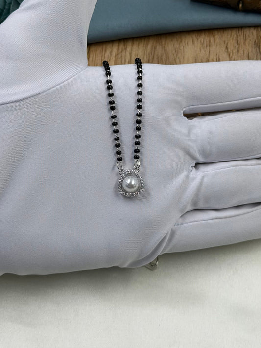 White Mangalsutra detail shot showing intricate work